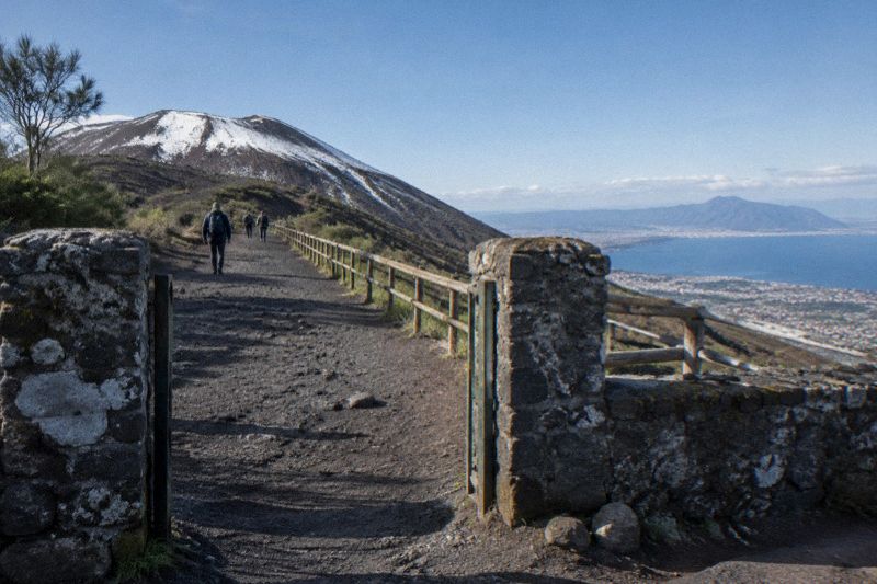 Snow patches on the upper cone of Vesuvius with cold clear air and the bay sharp below