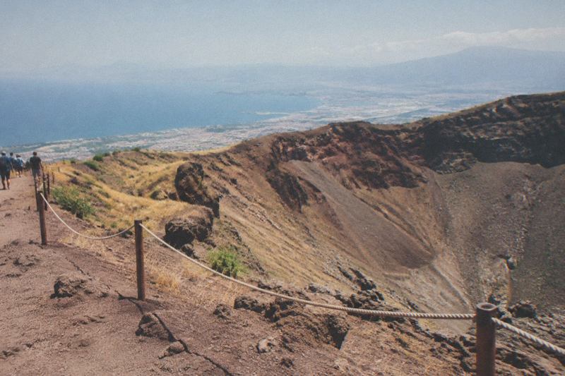 Vesuvius cone in hot summer haze over the Bay of Naples with dry golden slopes and a clear bright sky