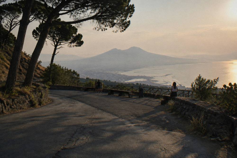 The Ercolano road winding up the slopes of Vesuvius with the Bay of Naples visible below