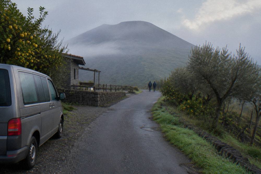 Country road winding uphill through orchards on the lower slopes of Mount Vesuvius