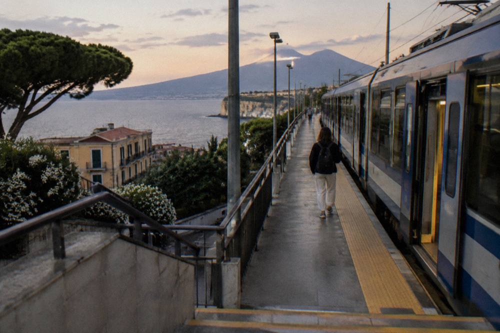 A Circumvesuviana train at a station platform on the Sorrento line