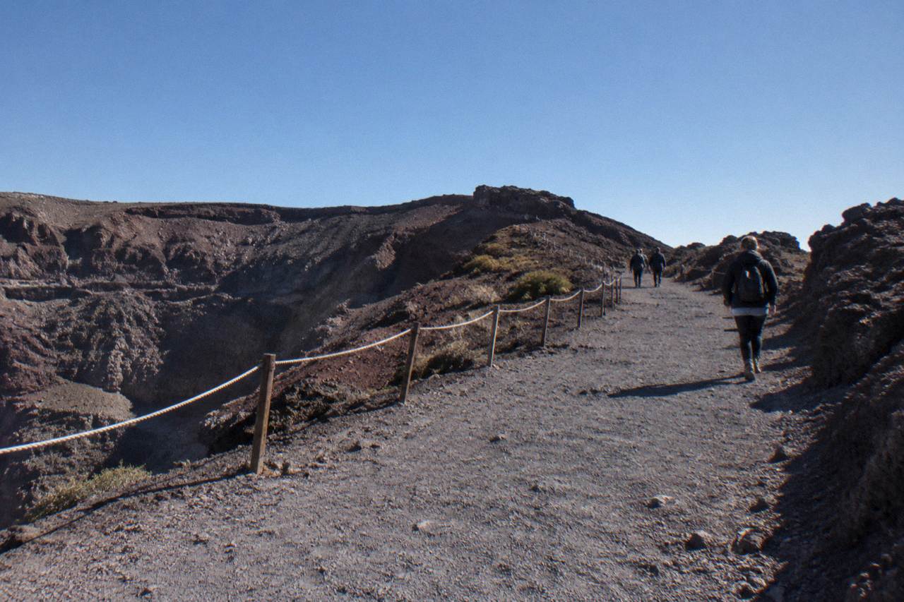 The gravel crater path of Mount Vesuvius climbing toward the rim under a clear sky
