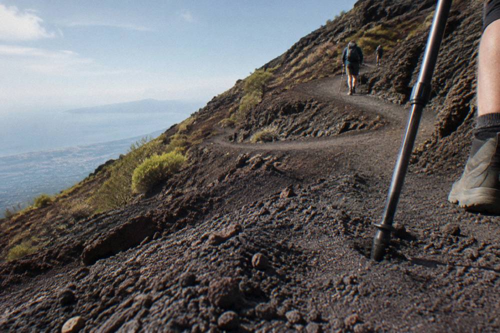 Dark ash switchbacks on the Gran Cono trail climbing toward the Vesuvius crater.