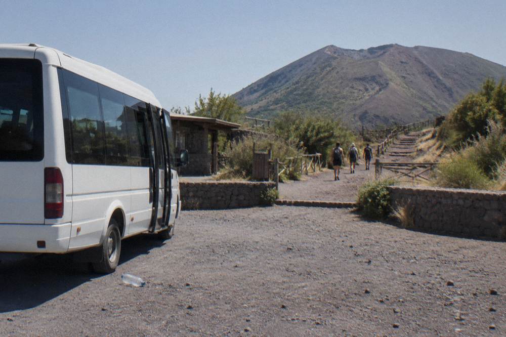 A tour minibus parked at the Quota 1000 plaza below the Vesuvius trailhead.