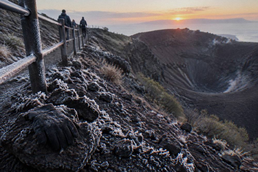 Frost on dark volcanic gravel along the Vesuvius crater trail