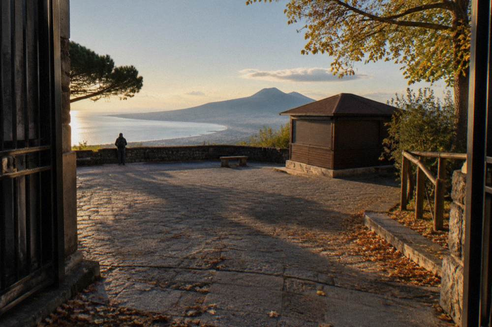 The Vesuvius trailhead plaza under autumn light with the Bay of Naples below