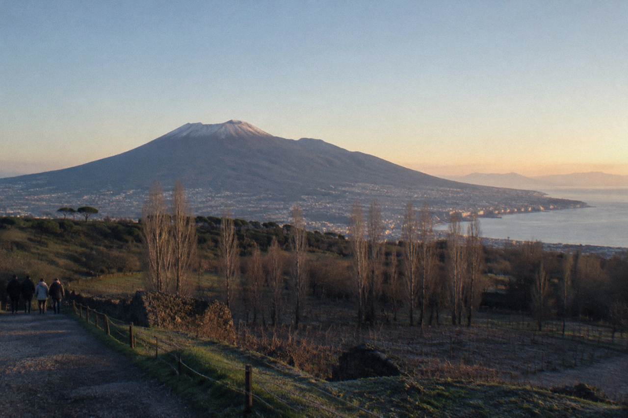 The Gran Cono crater of Mount Vesuvius under a wide sky above the Bay of Naples