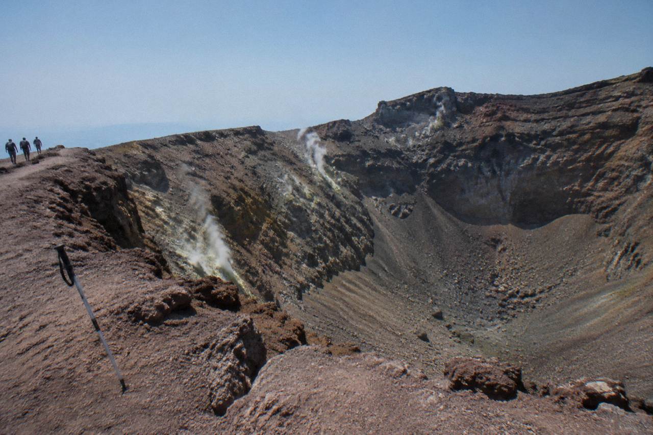 The crater of Mount Vesuvius with steam rising from fumaroles on a clear day