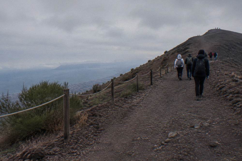 Trail path climbing toward the Gran Cono crater rim with Bay of Naples below