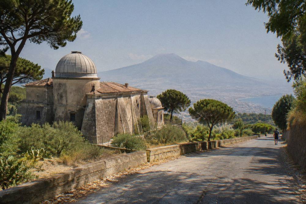 A winding provincial road climbing the green slopes of Mount Vesuvius