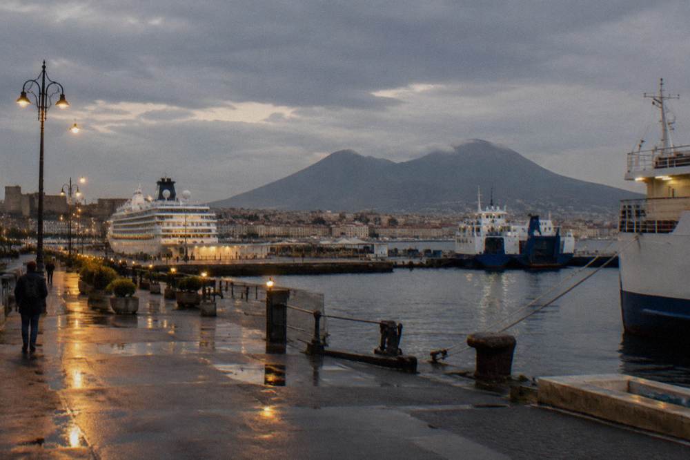 The skyline of Naples with the profile of Vesuvius rising behind the city rooftops
