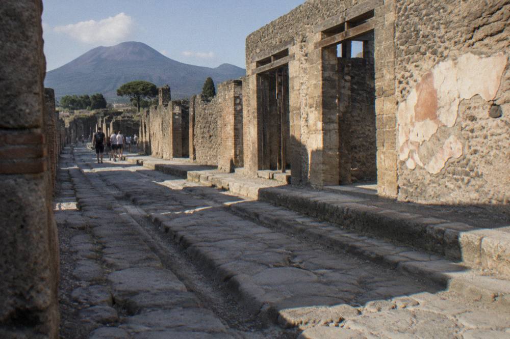 Ancient stone walls and paving in the Pompeii archaeological site with afternoon sunlight