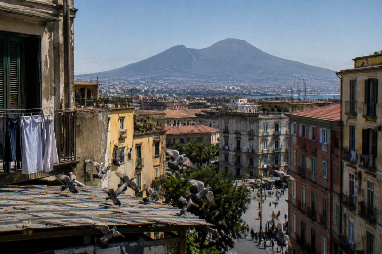 View of Mount Vesuvius rising above the rooftops of the Naples area at midday