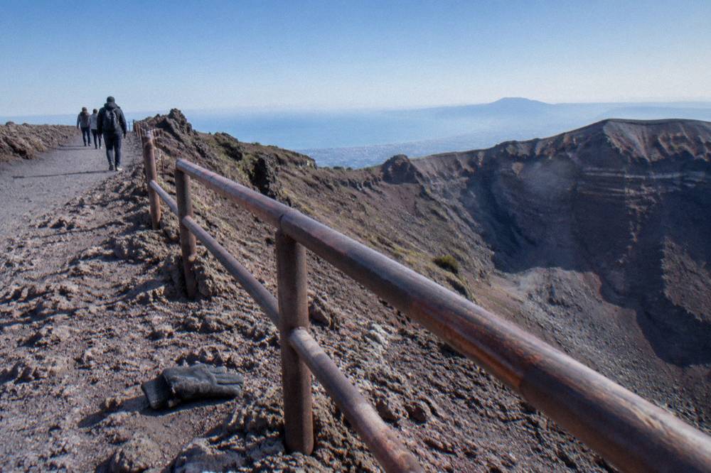 The crater rim of Vesuvius under a wide sky with the path along the edge