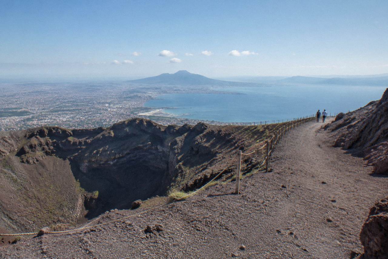 The Gran Cono crater trail of Mount Vesuvius under a clear sky with the Bay of Naples in the distance