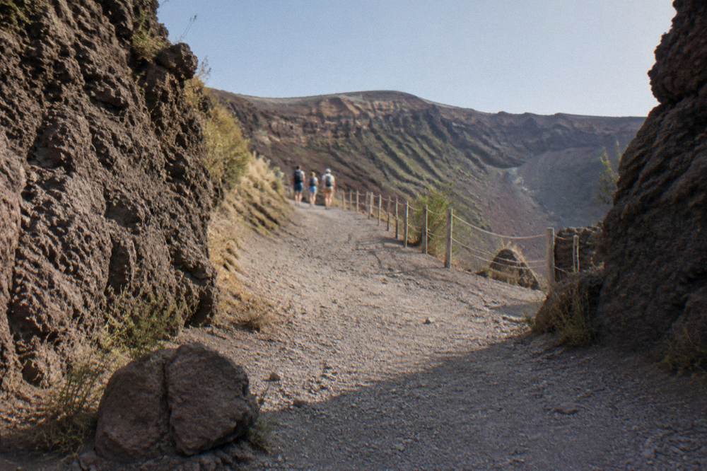 Visitors walking the graded gravel path up toward the crater rim