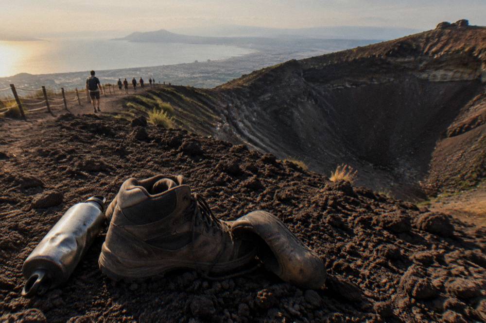 Hiking boots and a filled water bottle resting at the edge of the crater trail