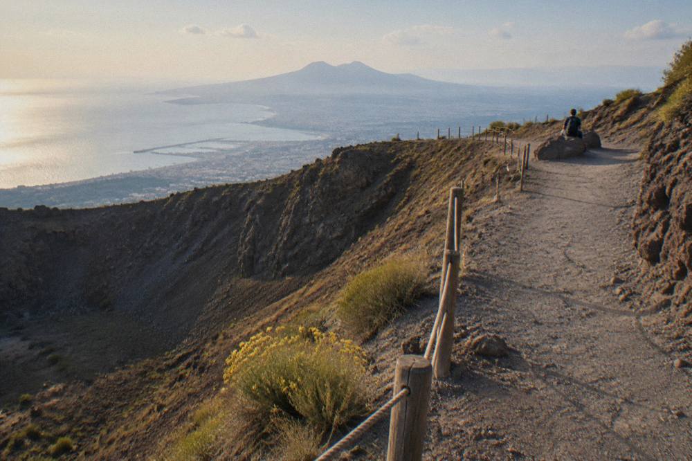 A gently rising gravel trail on the slopes of Vesuvius with wide views over the Bay of Naples