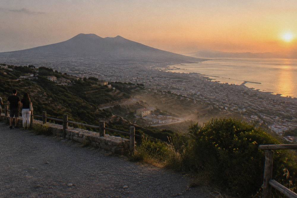 Towns and vineyards spread across the lower slopes of Mount Vesuvius toward the Bay of Naples