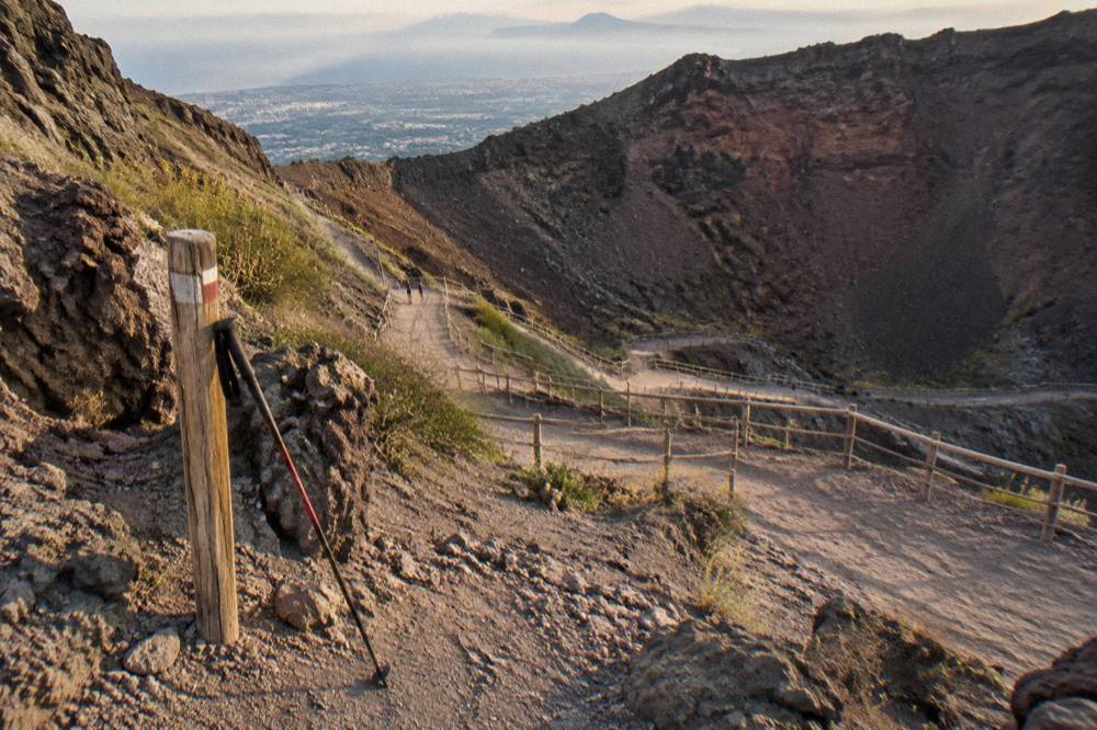 The final crater trail zigzagging down volcanic ash in late afternoon light