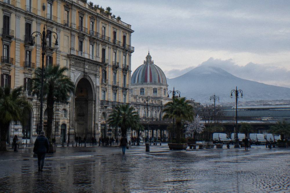 Morning light over Piazza Garibaldi in Naples with the station building and waiting tour vans