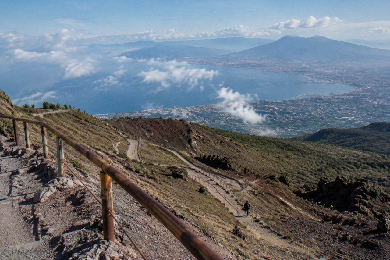 Winding path up the ash slopes of Mount Vesuvius toward the crater rim under a wide sky