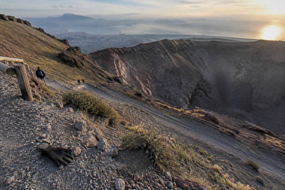 The Vesuvius crater trail winding up through grey volcanic gravel