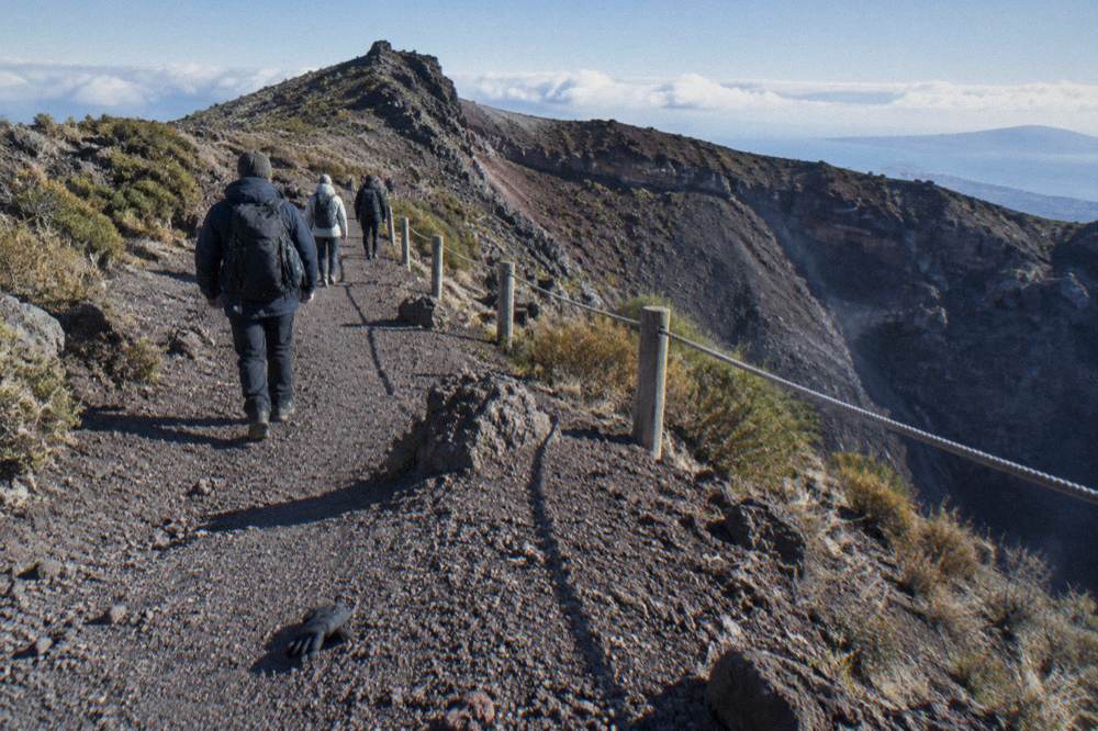 Volcanological guide leading walkers along the crater path of Vesuvius
