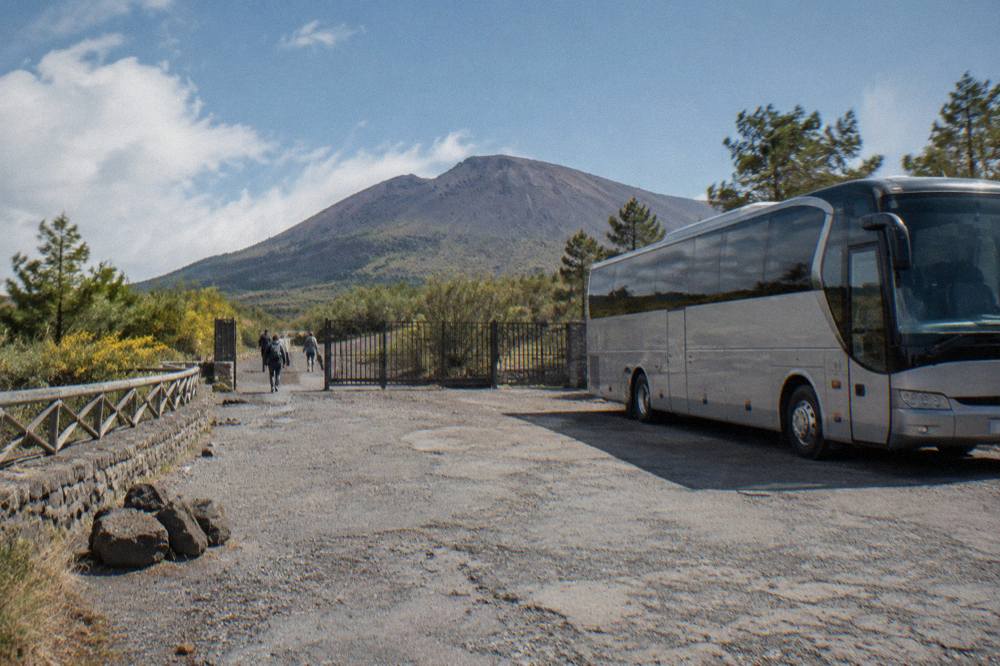 Bus parked at the Quota 1000 trailhead plaza below the Vesuvius crater path