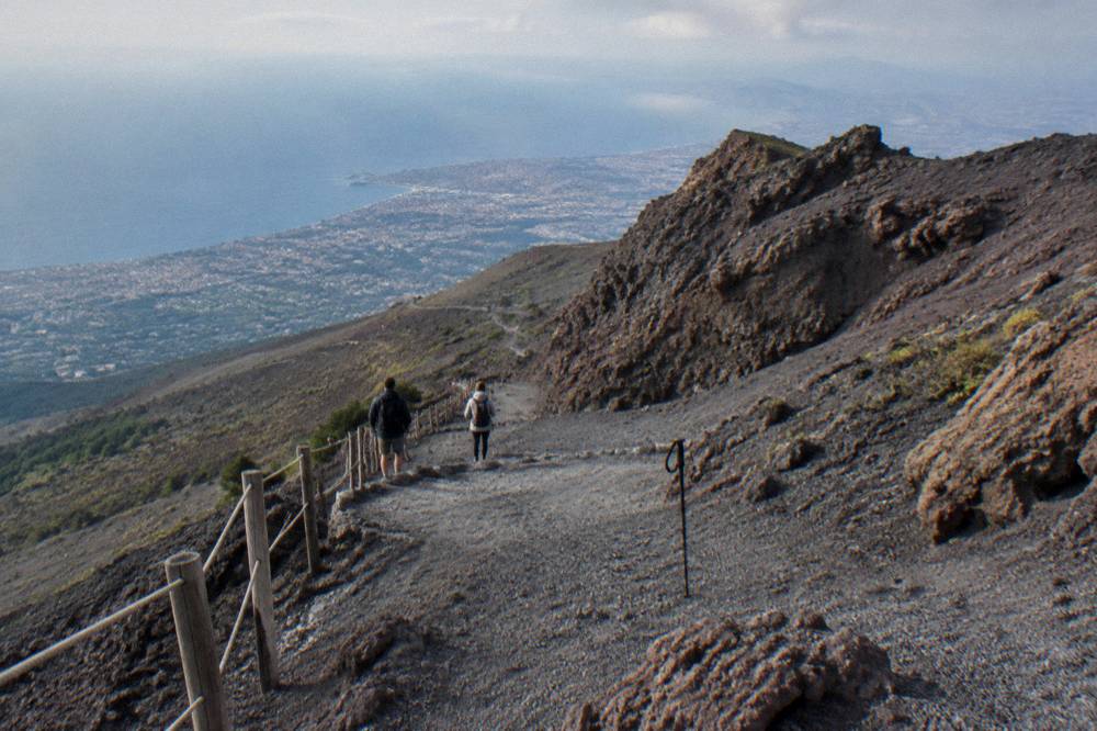 Visitors walking the crater trail path on the Vesuvius upper slope in clear conditions