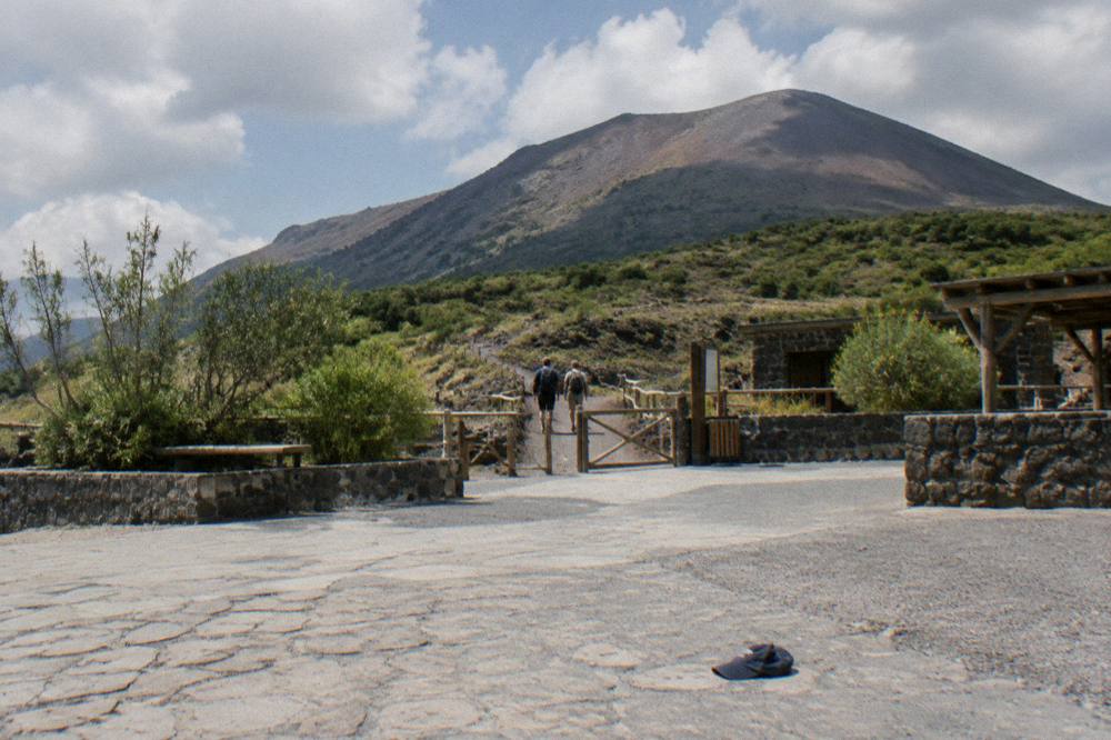 The path from the parking area toward the Vesuvius trailhead under a partly cloudy sky