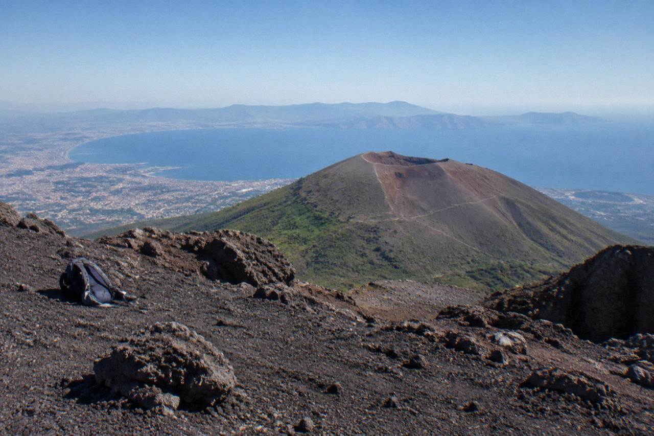 The Vesuvius crater rim under a clear sky above the Bay of Naples