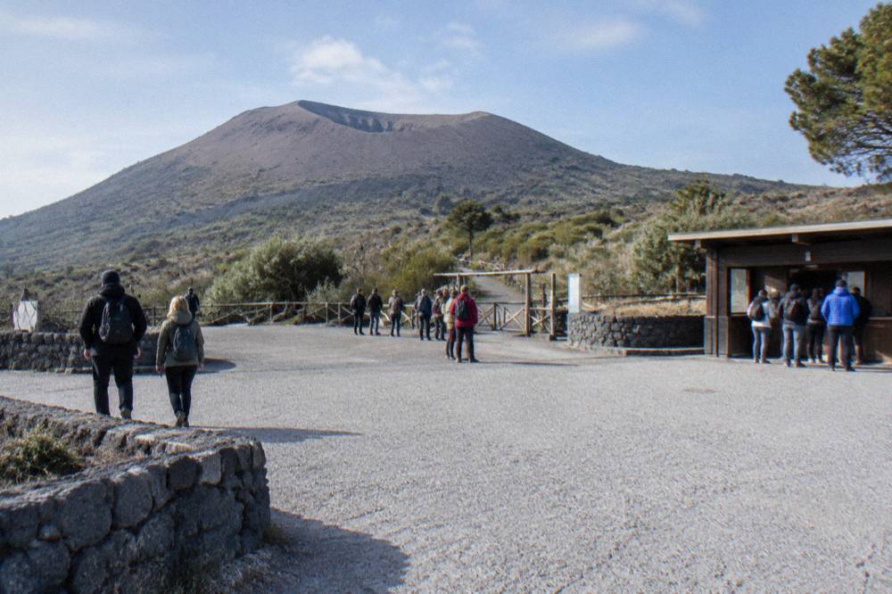 Visitors gathered at a stone plaza on Mount Vesuvius before the crater path