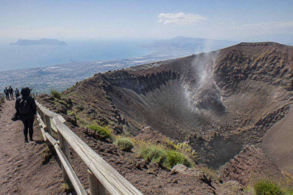 The wide elliptical crater of Vesuvius seen from the public rim viewpoint under open sky