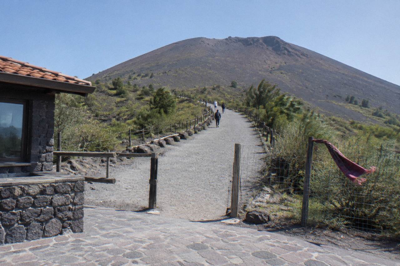 The Gran Cono crater path of Mount Vesuvius under a clear sky with volcanic rock underfoot