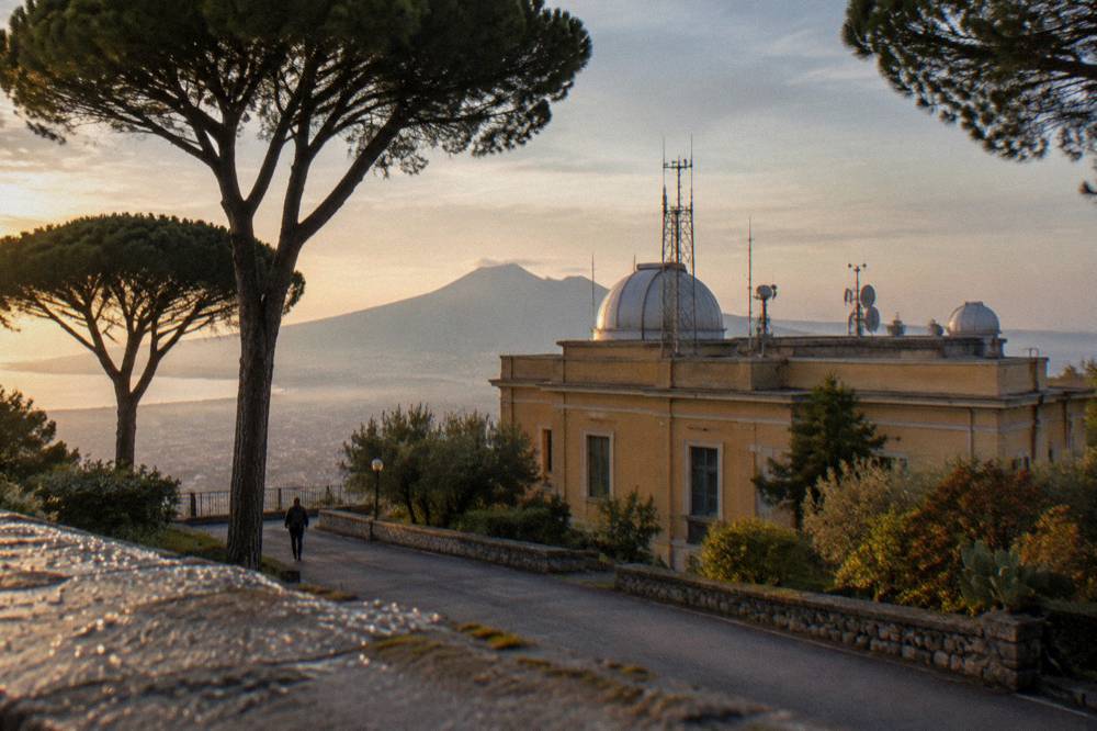 The observatory buildings and monitoring equipment on the volcano's upper slope above pine woodland